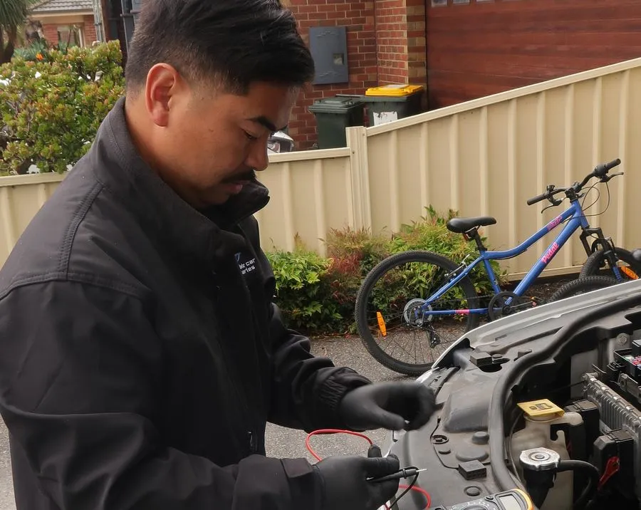 Alex hardwiring a dashcam at a customer's home